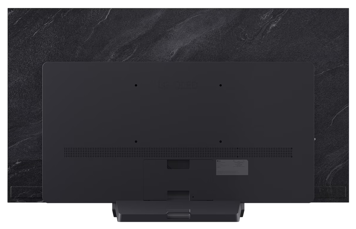Tył czarnego telewizora, pokazujący porty, podstawę i teksturowaną, ciemnoszarą powierzchnię.