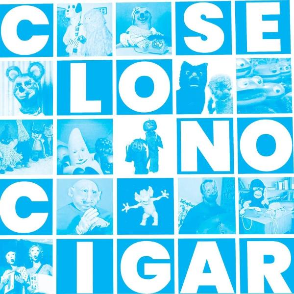 Albumcover: Blaue Quadrate mit verschiedenen Figuren und Text, 'Close, Los, No, Cigar'.