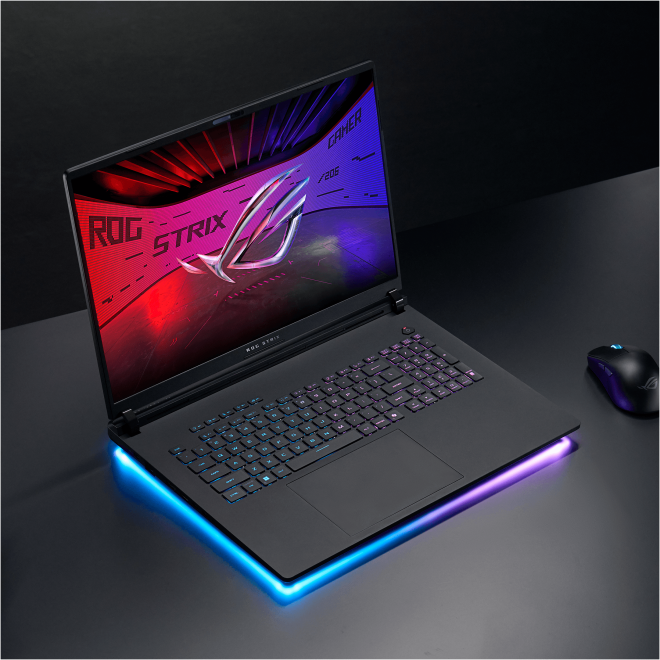 Nyitott laptop, billentyűzetet és képernyőt mutatva, egérrel és világító szélekkel, fekete háttér.