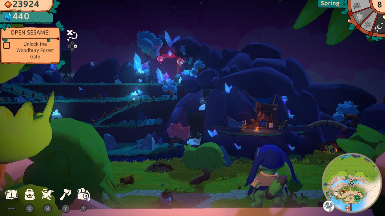 Eine Nachtszene aus einem Videospiel. Felsen, Bäume und Kristalle werden von blauem Licht beleuchtet.