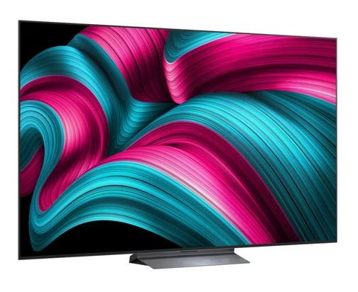 Büyük, siyah bir TV, siyah bir arka plan üzerinde pembe ve mavi renklerde canlı bir soyut tasarım sergiliyor.