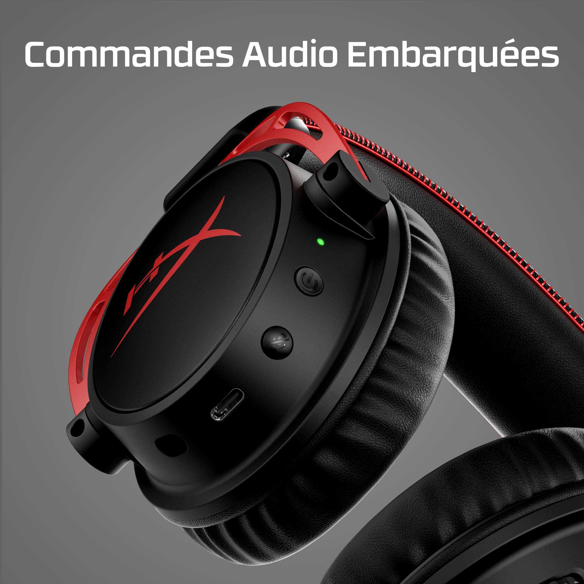 Black and red HyperX headphones. The left earcup has a red X logo and buttons. Gray background.