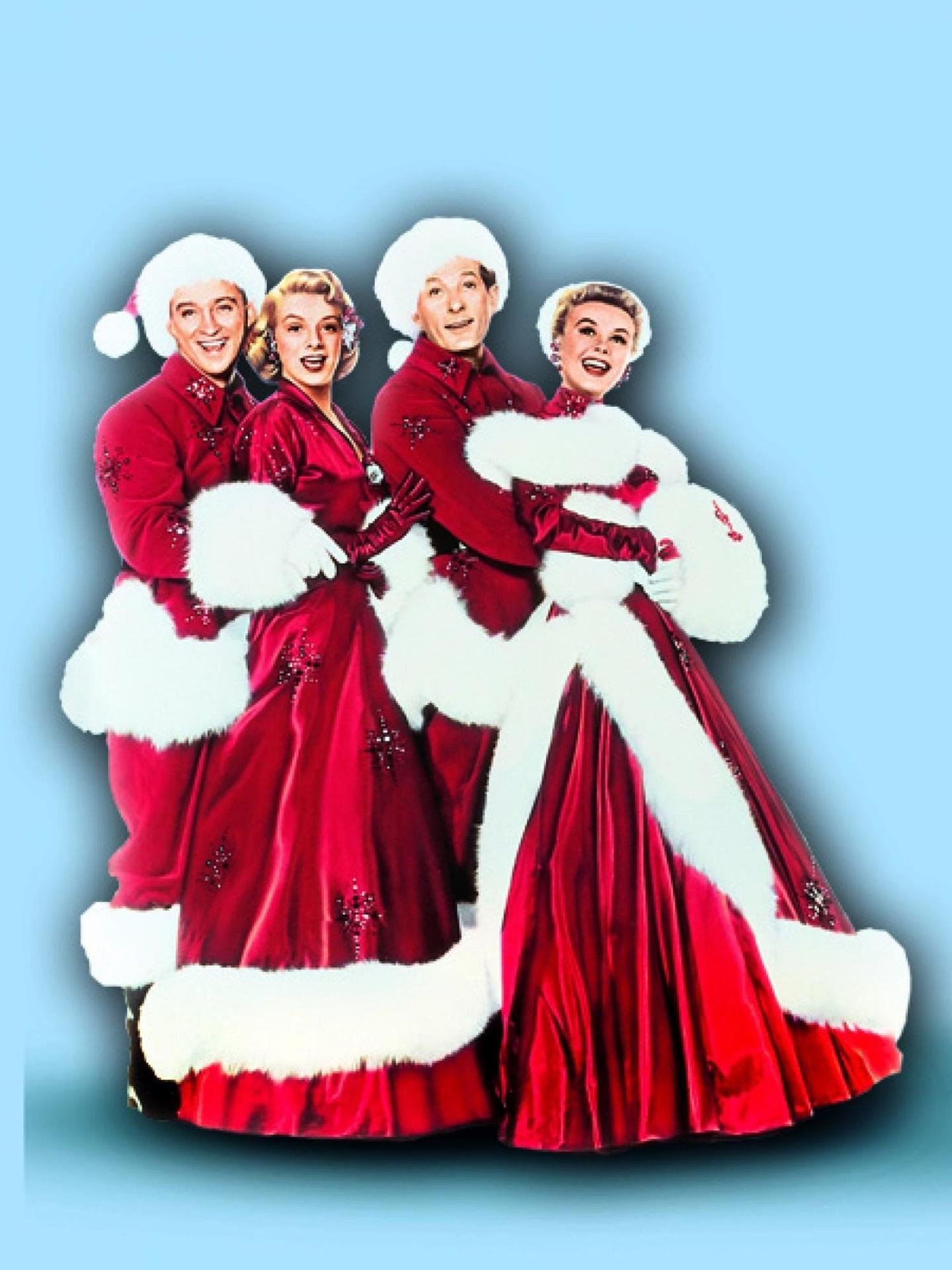 Vier Personen in Weihnachtsmann-Outfits, rot und weiß, lächeln. Blauer Hintergrund.