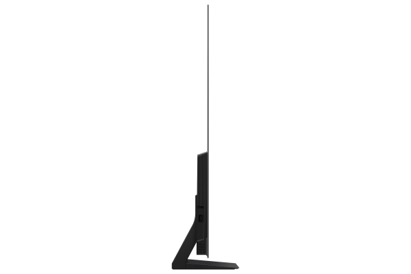 Siyah bir OLED televizyonun, minimal bir stand ve siyah bir arka plan ile yan görünümü.