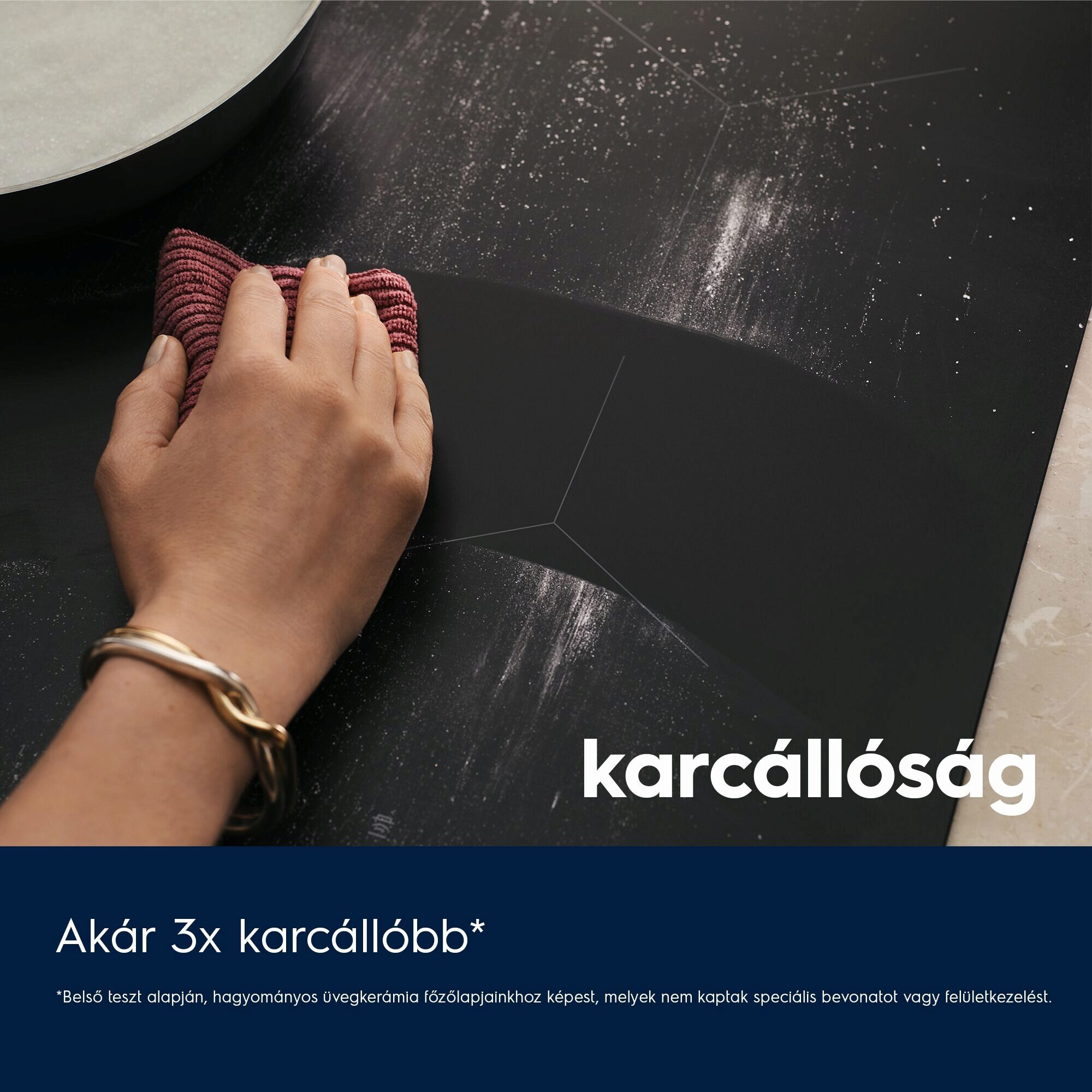 Kéz tisztítja a fekete főzőlapot. Fehér por és 'karcollassag' felirat. Rózsaszín kendő.