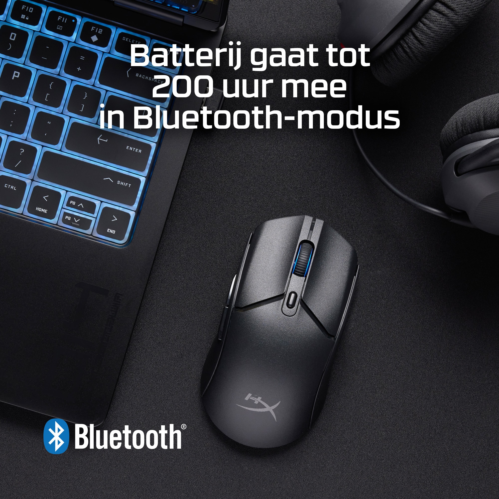 A black mouse on a desk with a laptop. Text: battery lasts up to 200 hours in Bluetooth mode.