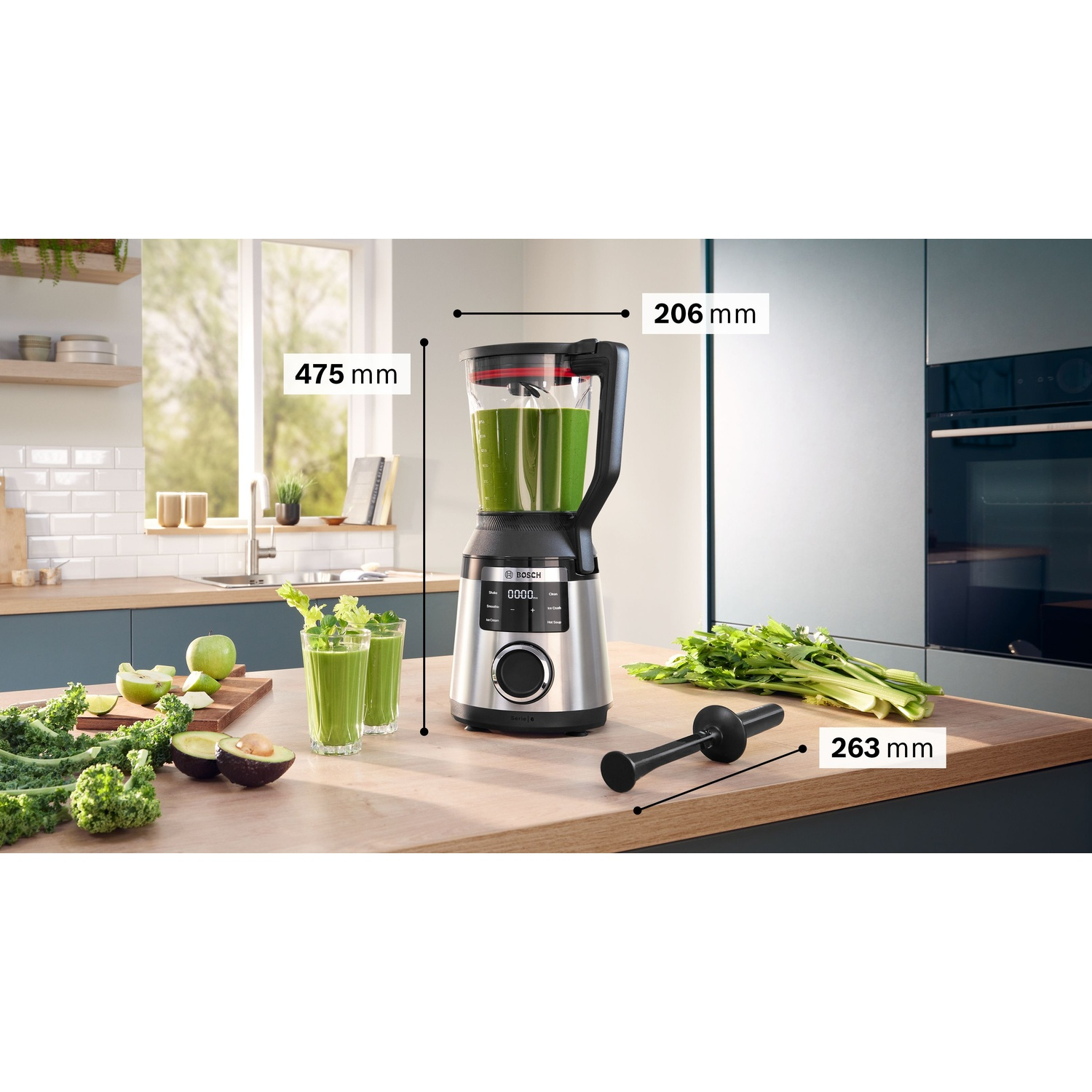 Un frullatore con una miscela verde. Le dimensioni sono indicate come 475 mm e 206 mm. Bicchieri di frullato verde sul tavolo.
