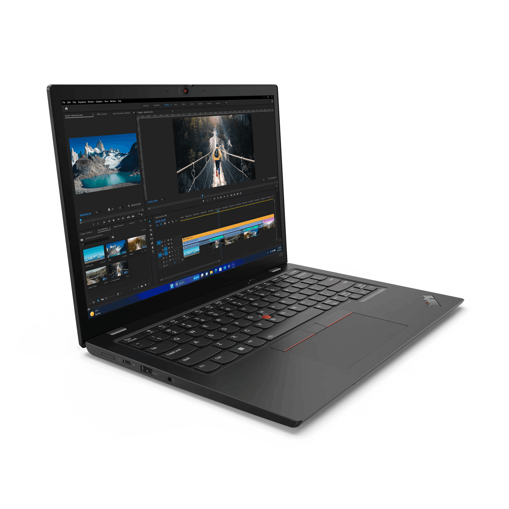Portátil abierto, mostrando software de edición de vídeo. Teclado y pantalla negros, con un paisaje montañoso.