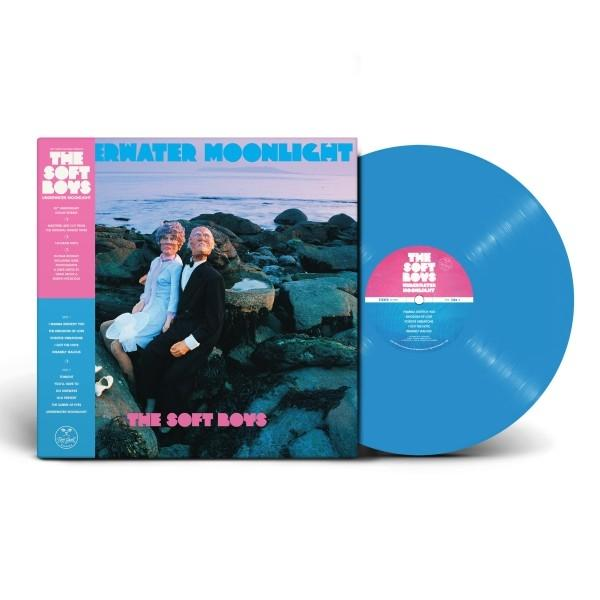 Albumcover mit zwei Personen, die auf Felsen sitzen, und einer blauen Schallplatte.