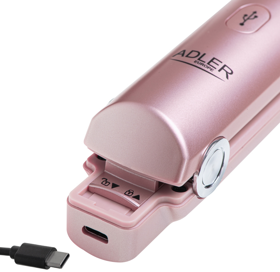 Rózsaszín hajvasaló USB-C töltőporttal és nyitott zárómechanizmussal. Fekete háttér.