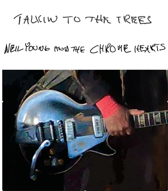 Eine Person hält eine Gitarre. Text: Talkin' to the Trees. Weißer Hintergrund.