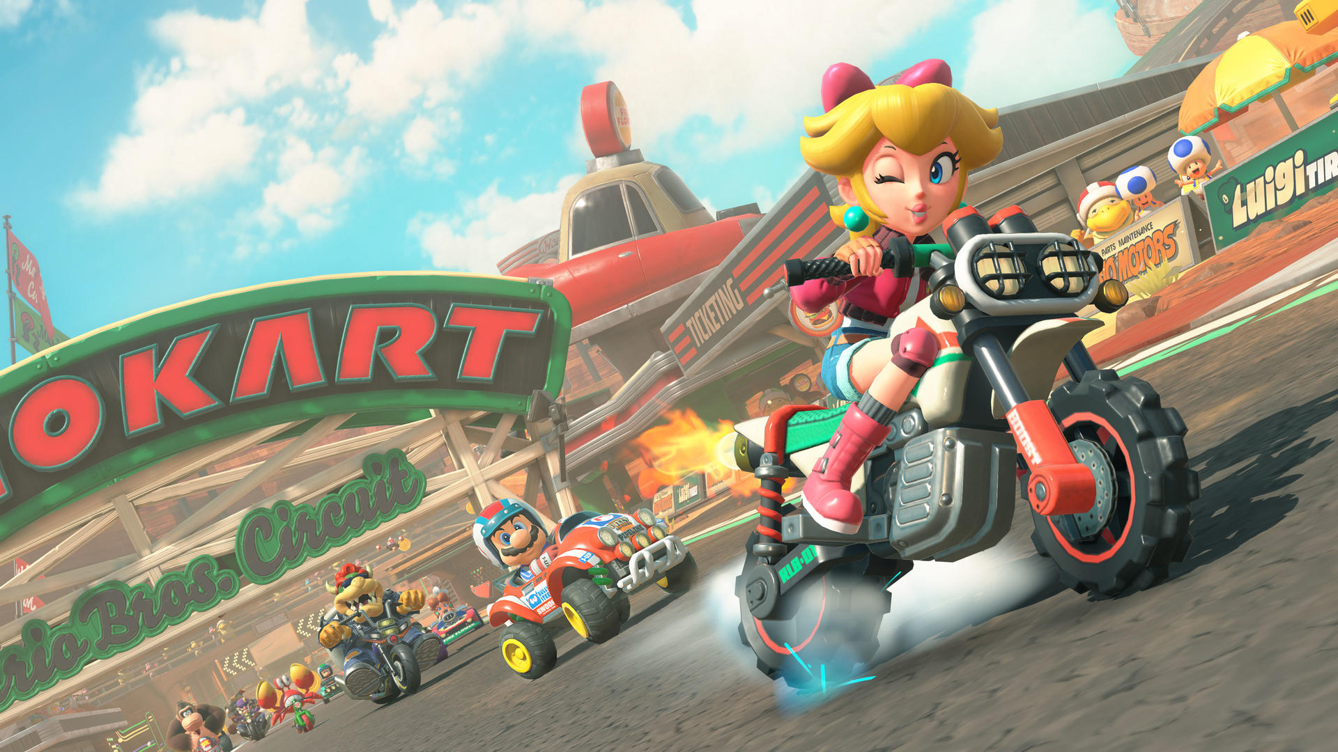 Prinzessin Peach auf Motorrad, führt Kartrennen mit anderen Charakteren an.