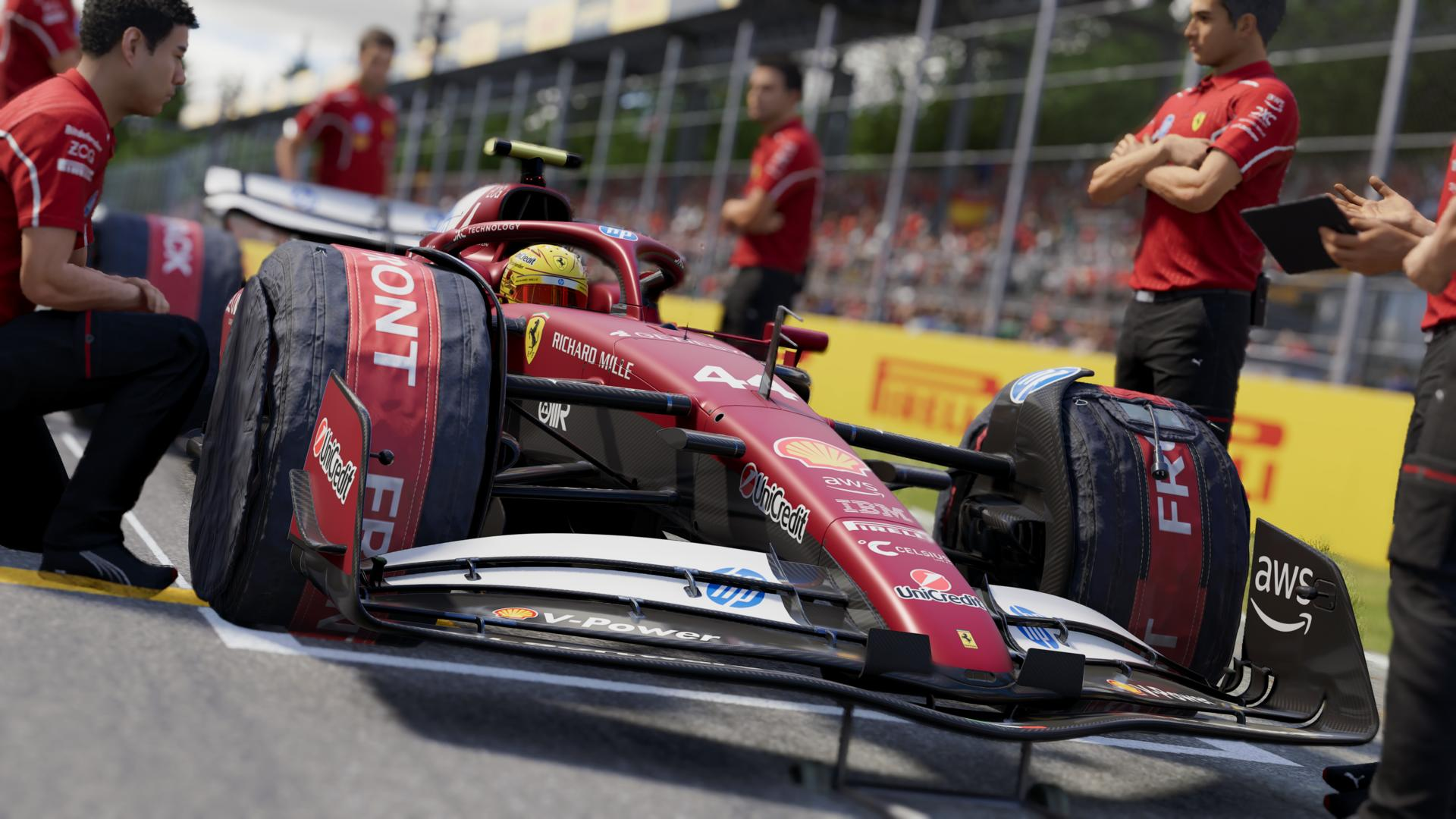 Ein Formel-1-Rennwagen bei einem Boxenstopp, mit einem roten Auto und Crewmitgliedern in roten Uniformen.