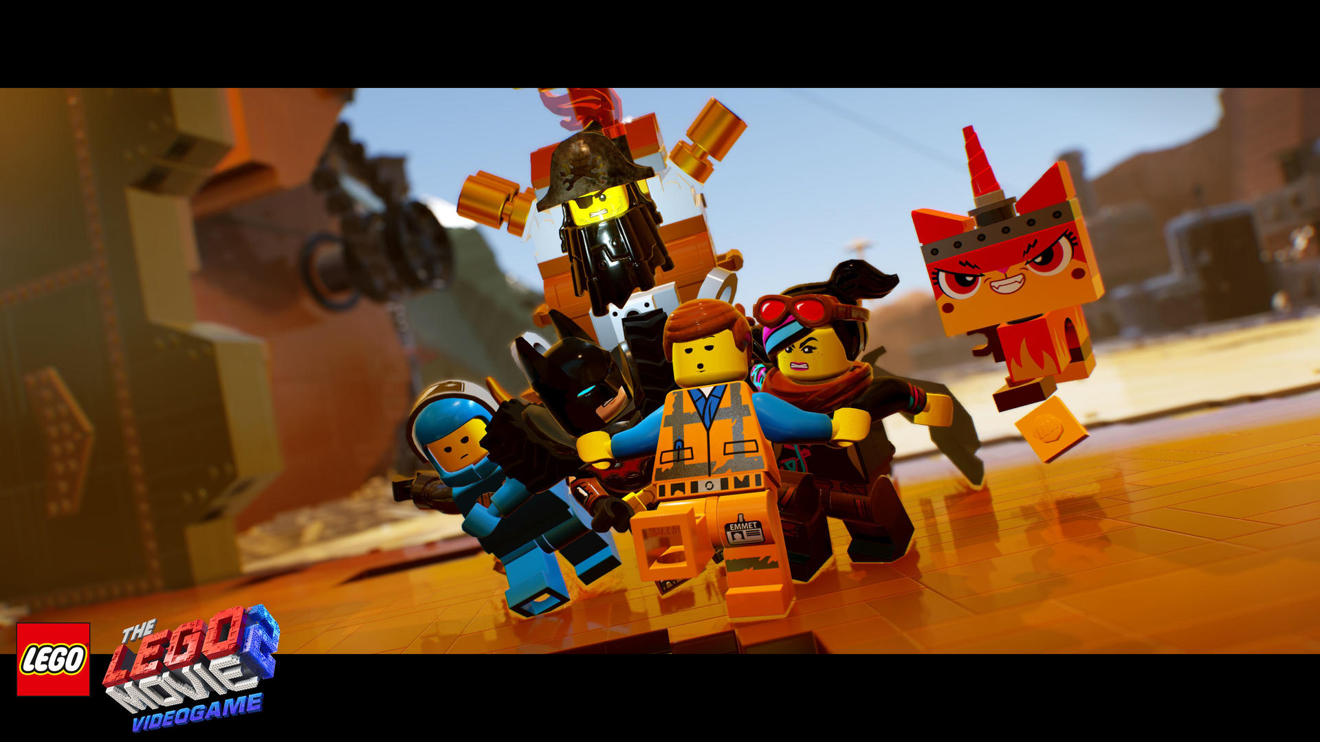 Scena z gry wideo LEGO Movie: postacie Lego zgromadzone razem, z logo na dole.