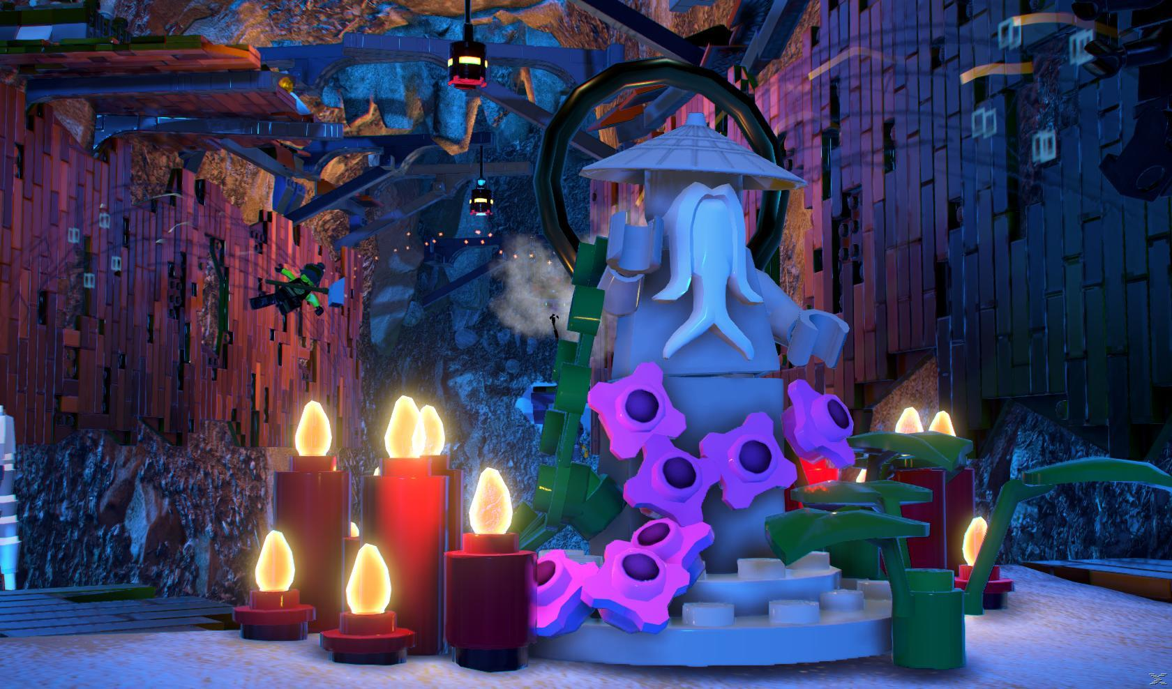 Scena z LEGO: posąg, świece i elementy dekoracyjne. Odcienie niebieskiego i fioletowego.