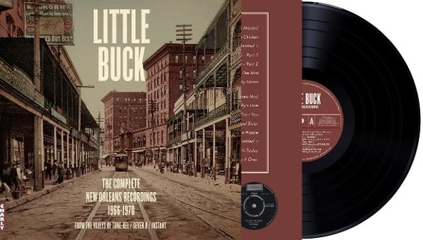 Albumcover mit Straßenszene, Titel 'Little Buck', Schallplatte und Text.