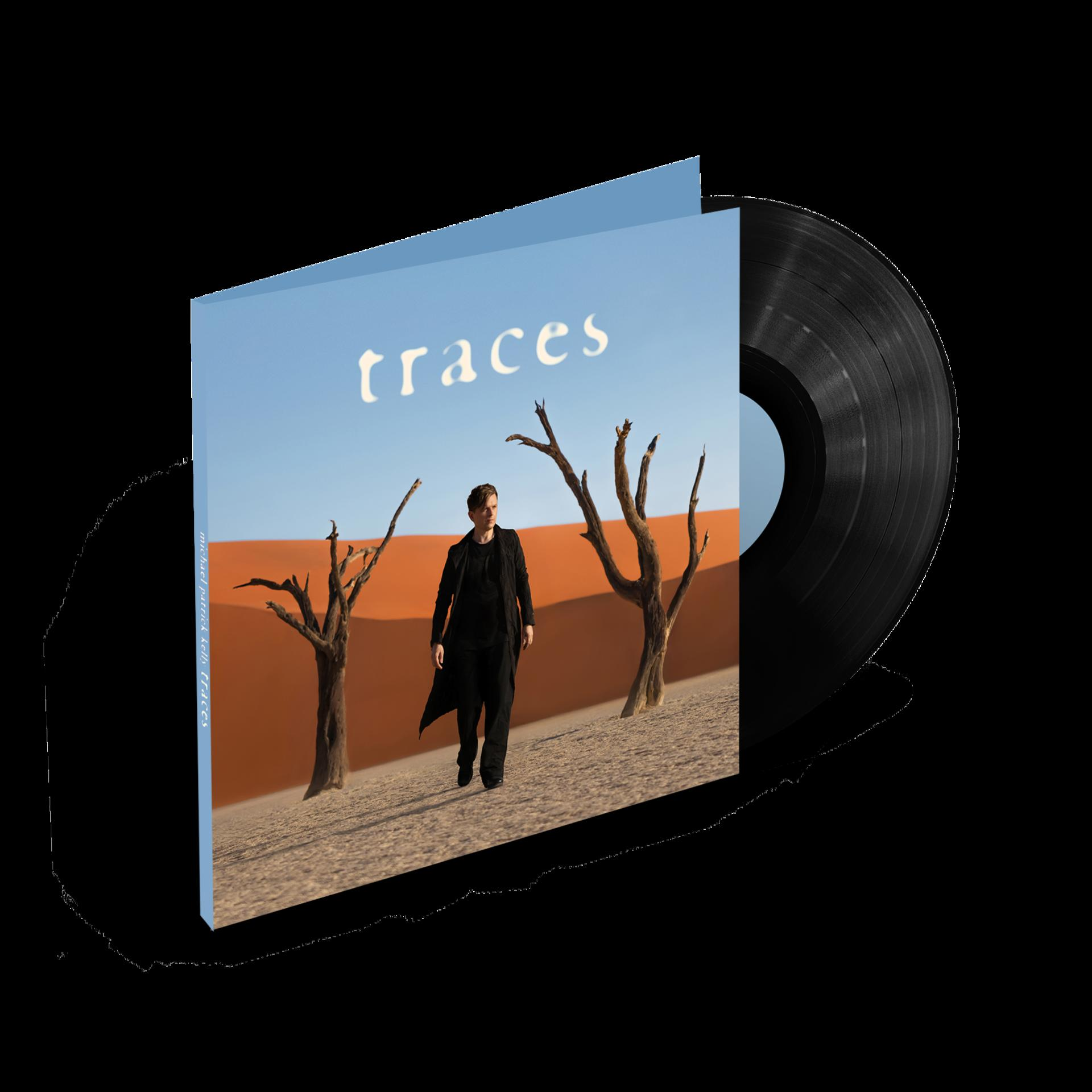 Albumcover mit einer Vinylplatte und einer Person, die in einer Wüste geht.
