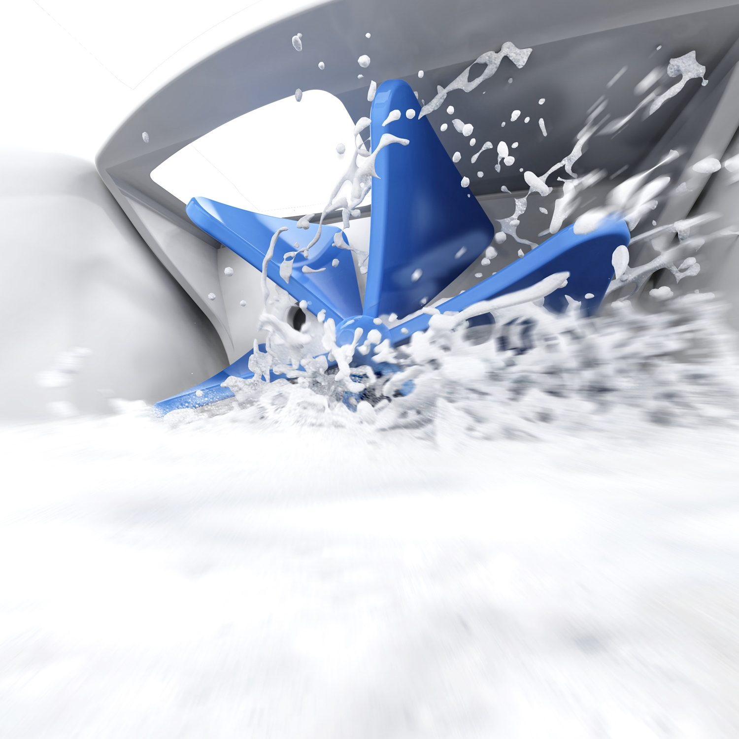 Pale blu ruotano in un liquido bianco. L'acqua schizza nella lavatrice.