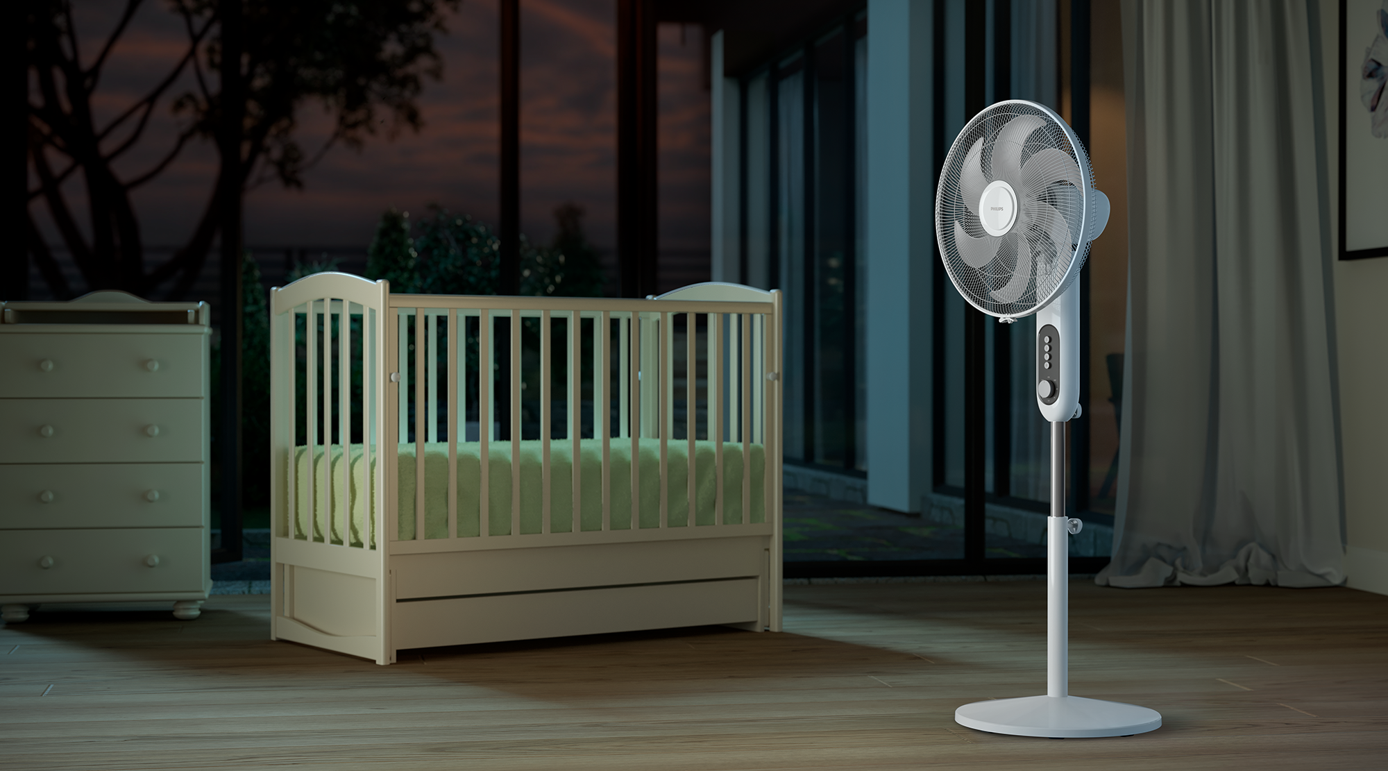 Fehér Philips ventilátor, kiságy és komód egy szobában. Sötét háttér esti fénnyel.