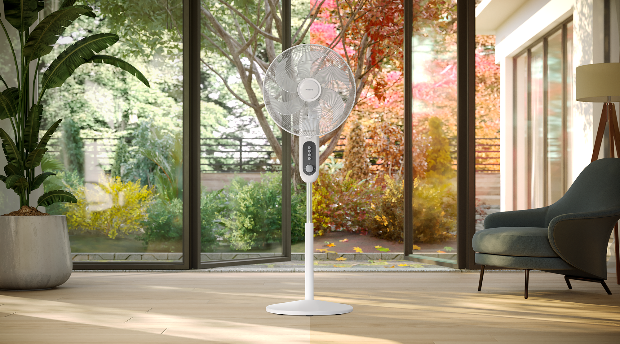 Egy fehér Philips ventilátor egy szobában kilátással, ami kényelmes beltéri környezetet sugall.