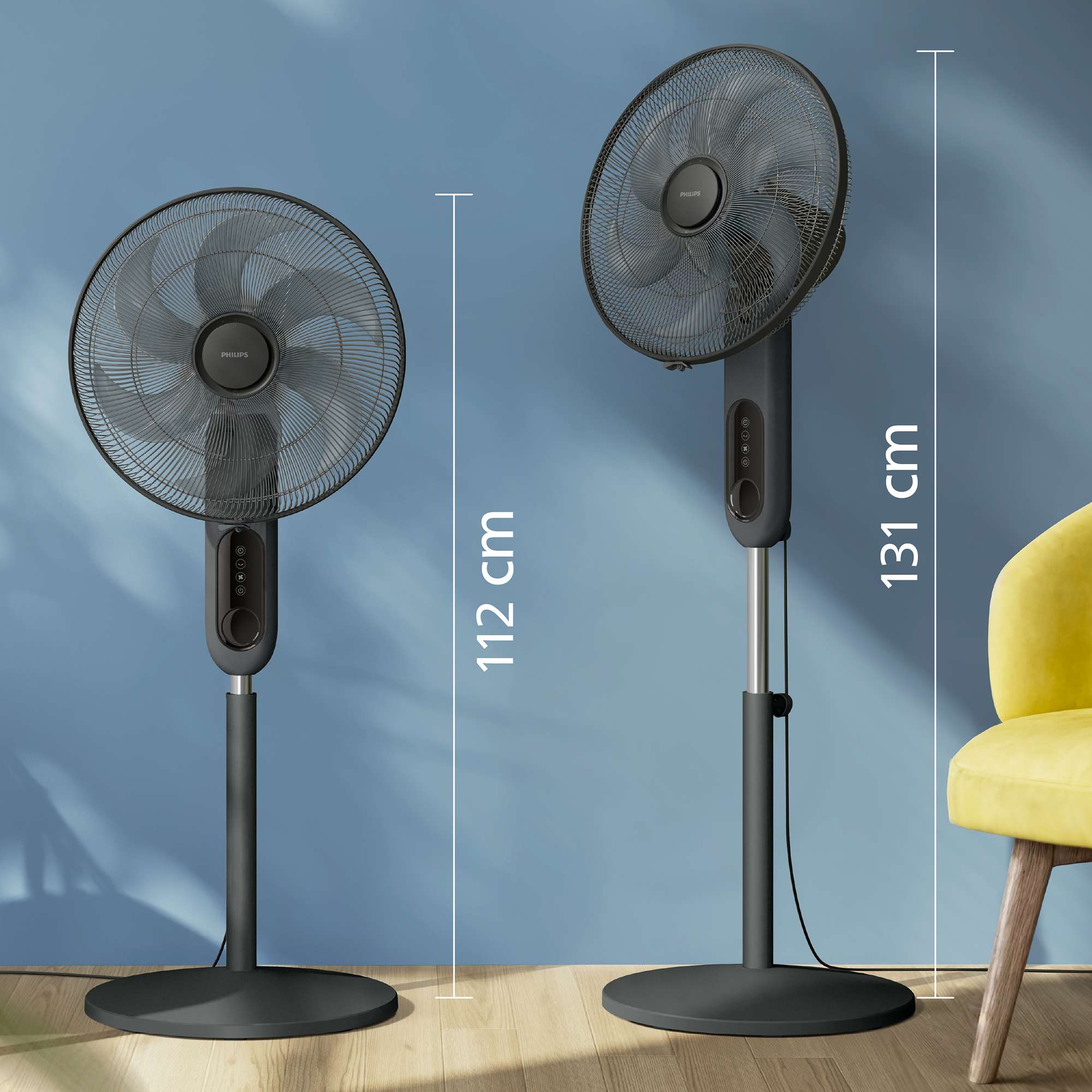Két Philips ventilátor, egy 112 cm-es és egy 131 cm-es, egy kék fal előtt, ami a magasságkülönbségeket jelzi.
