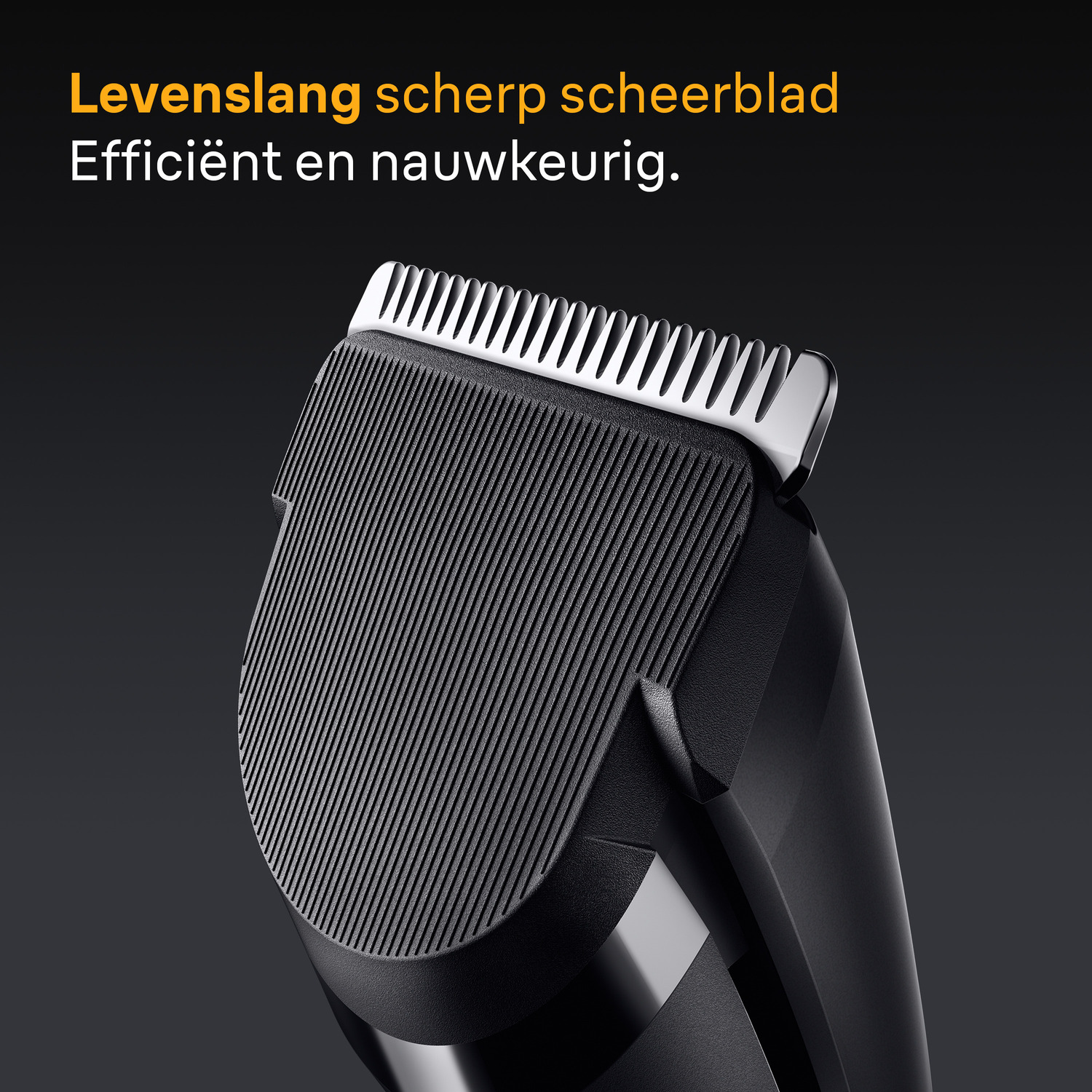 Close-up of a shaver head, black and silver, with text.