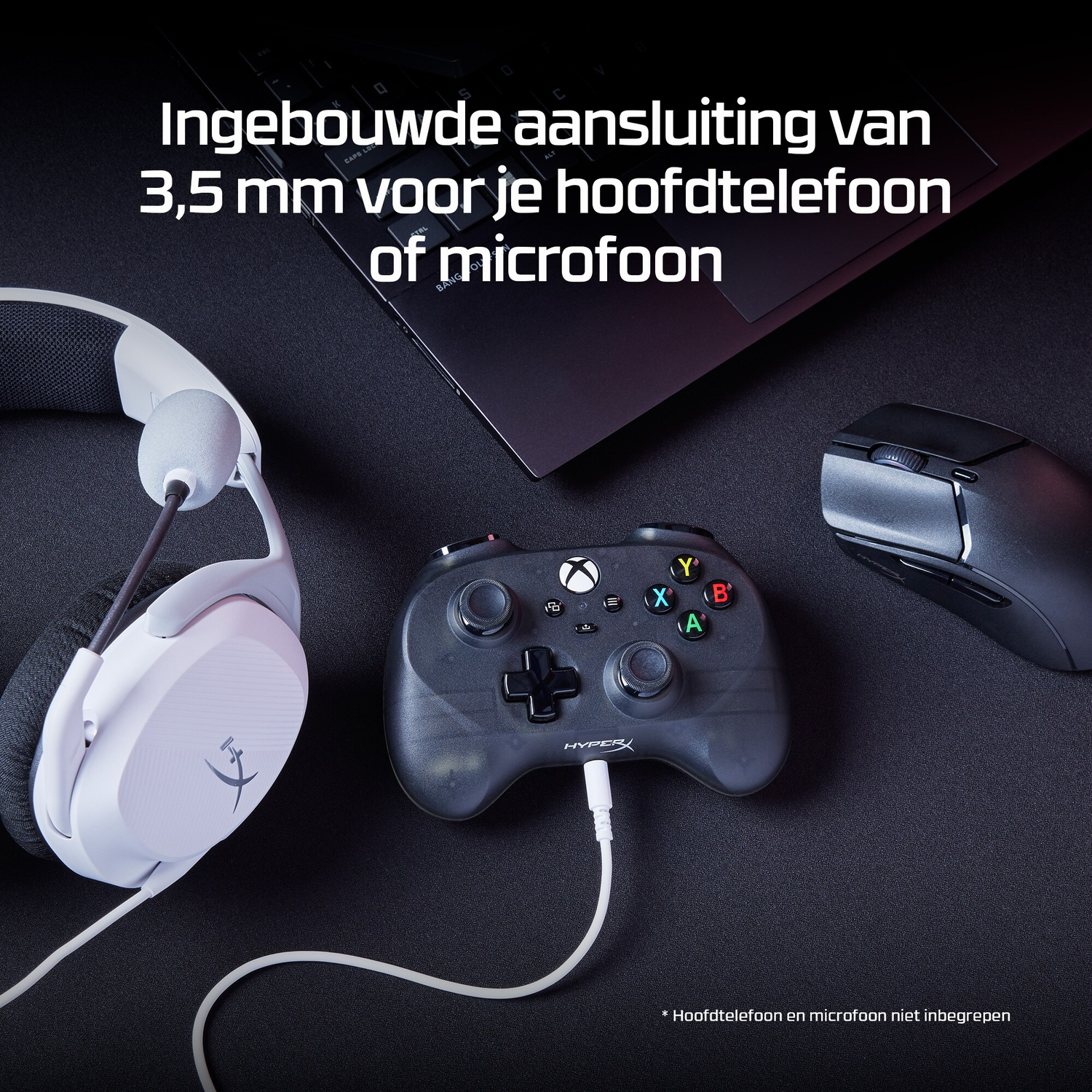Black controller, white headset, and black mouse on black surface. Laptop in background.