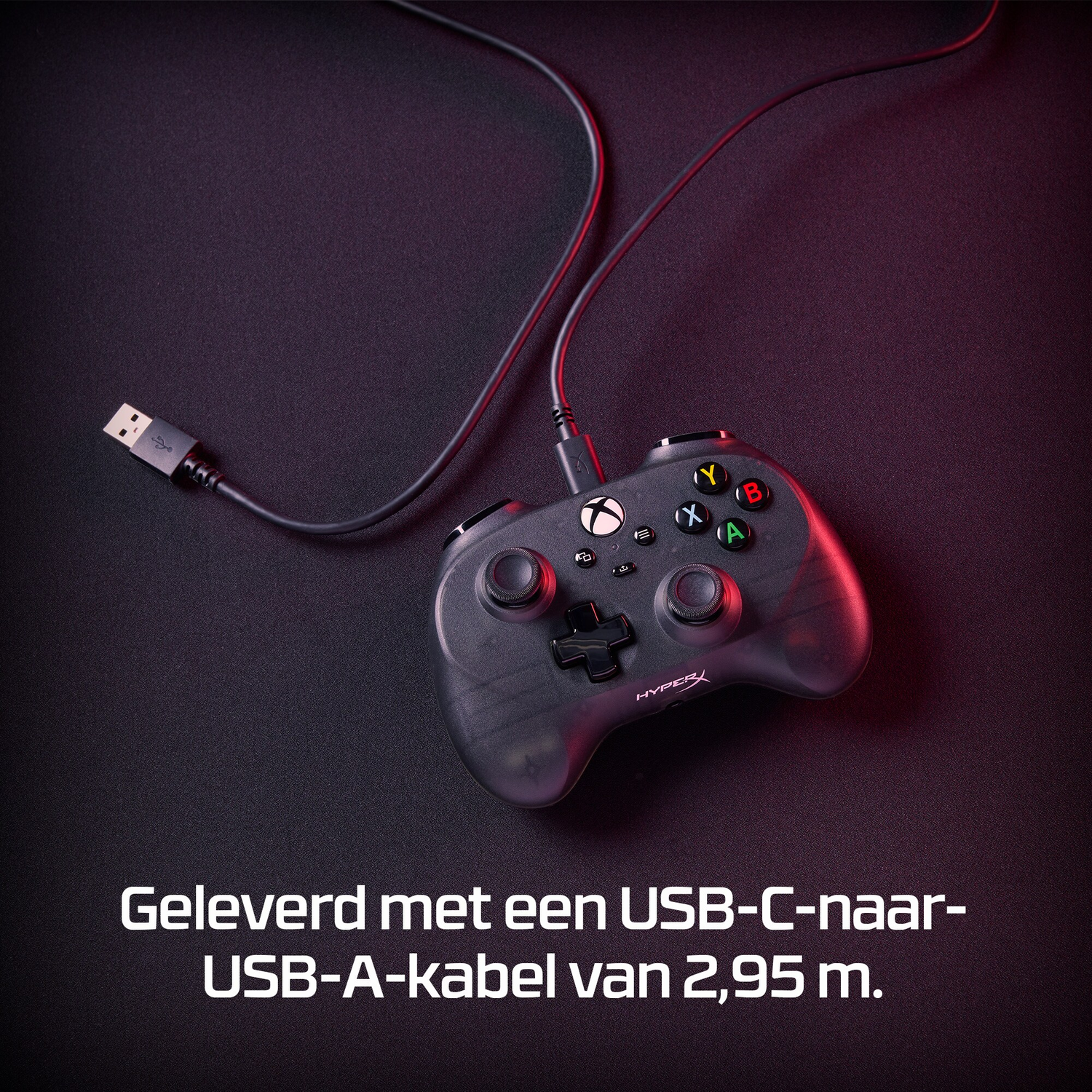 Black controller connected with a USB-C cable on a dark surface.  USB-A end is visible.