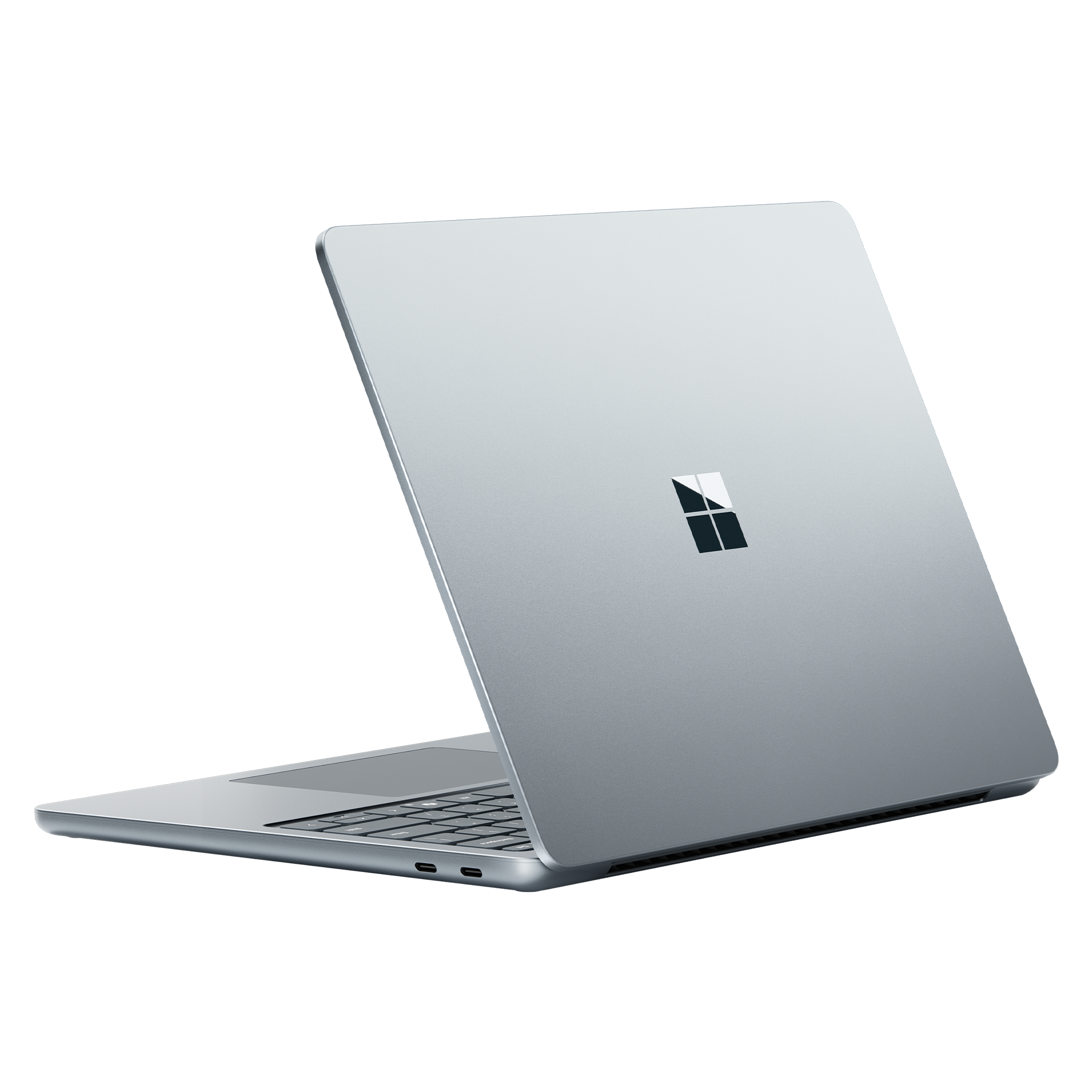 Portátil plateado desde atrás con logotipo de Microsoft sobre fondo negro.