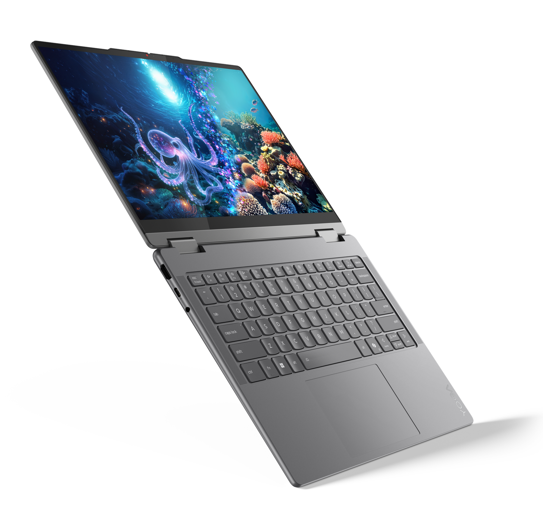 Laptop z ekranem wyświetlającym podwodną scenę z ośmiornicą i koralowcami.