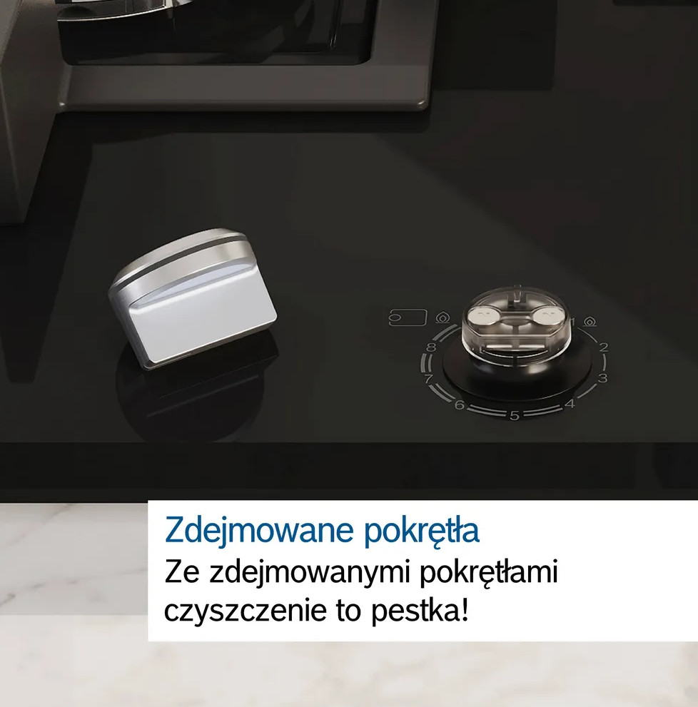 Zbliżenie czarnej kuchenki gazowej z usuniętym pokrętłem. Biały blat w tle.