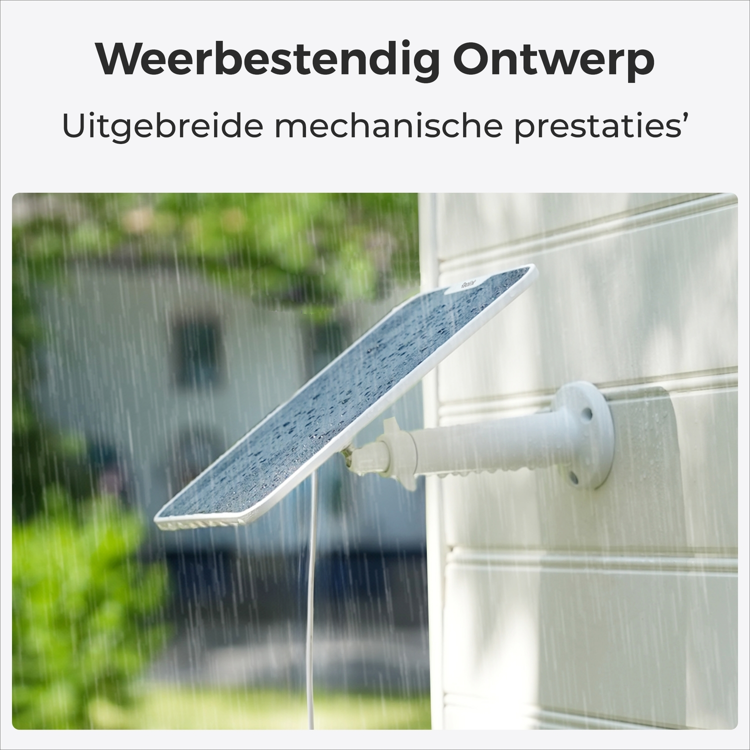 A solar panel is installed on a wall during the rain. Raindrops are visible on the solar panel.