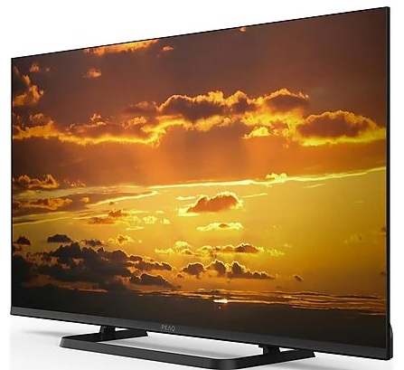 Czarny telewizor wyświetla scenę zachodu słońca w pomarańczowych i żółtych barwach.