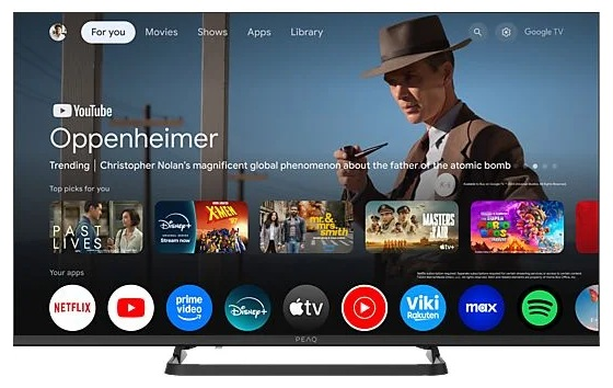 Telewizor wyświetla ekran wyboru filmów. Zawiera plakaty filmowe, ikony aplikacji i logo PEAQ.