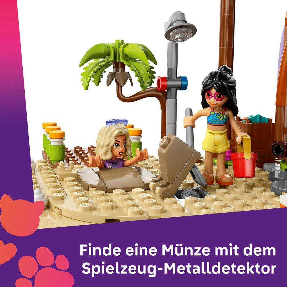 Ein Lego-Set zeigt eine Strandszene mit Figuren. Ein Mädchen sucht mit einem Metalldetektor nach einer Münze.