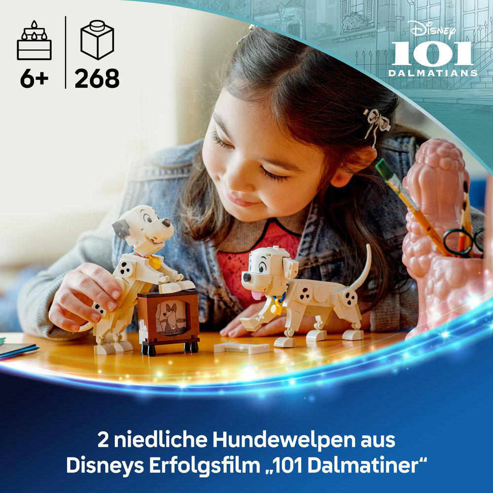 Junges Mädchen spielt mit einem 101 Dalmatiner LEGO Set. Zeigt zwei Dalmatiner-Welpen und einen braunen Fernseher.