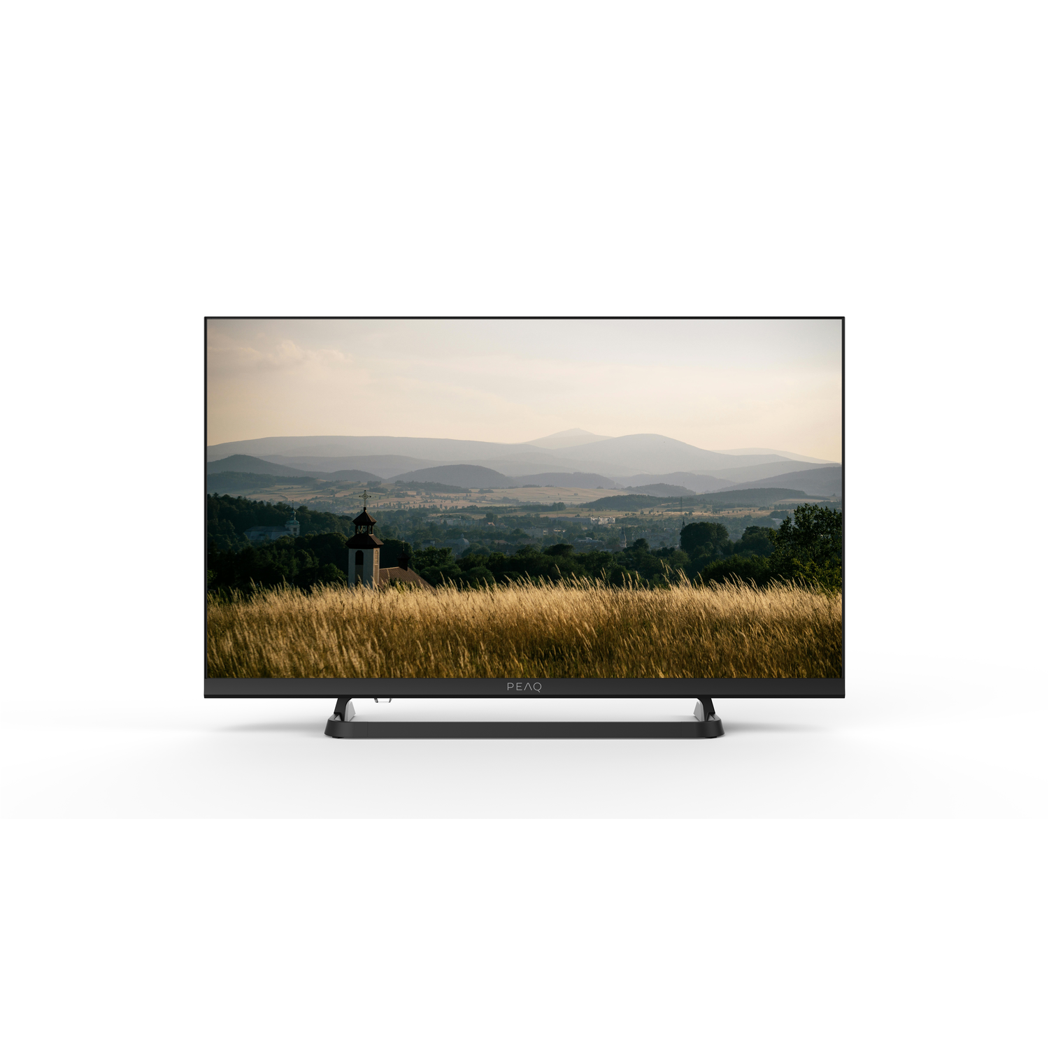 A TV shows a landscape with fields and mountains in the background.
