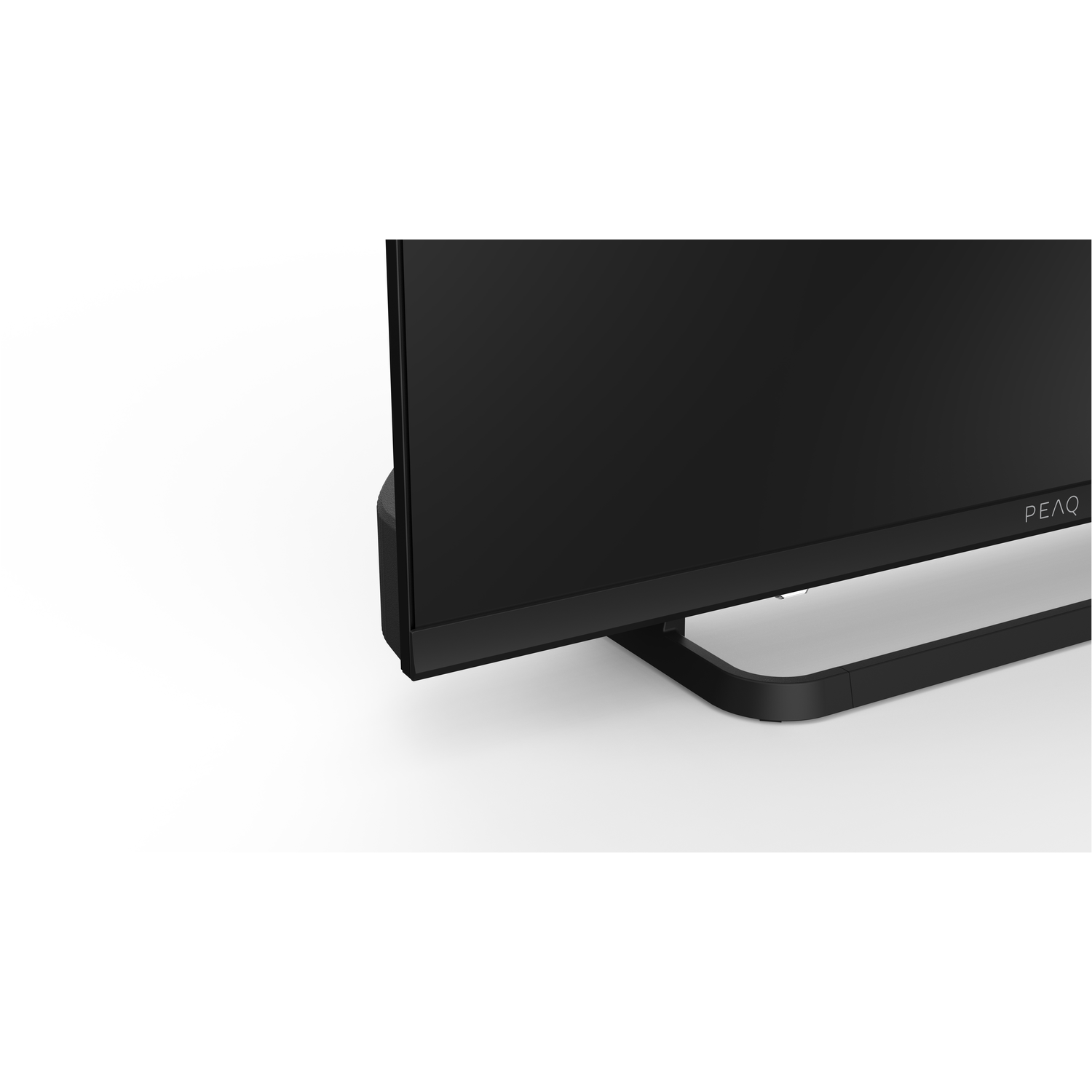 A close-up of a black TV, showing its base and the brand name PEAQ.