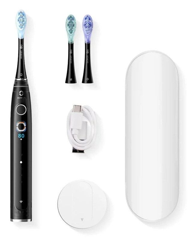 Czarna elektryczna szczoteczka do zębów z akcesoriami, w tym zapasowymi główkami, kablem ładującym i etui podróżnym.