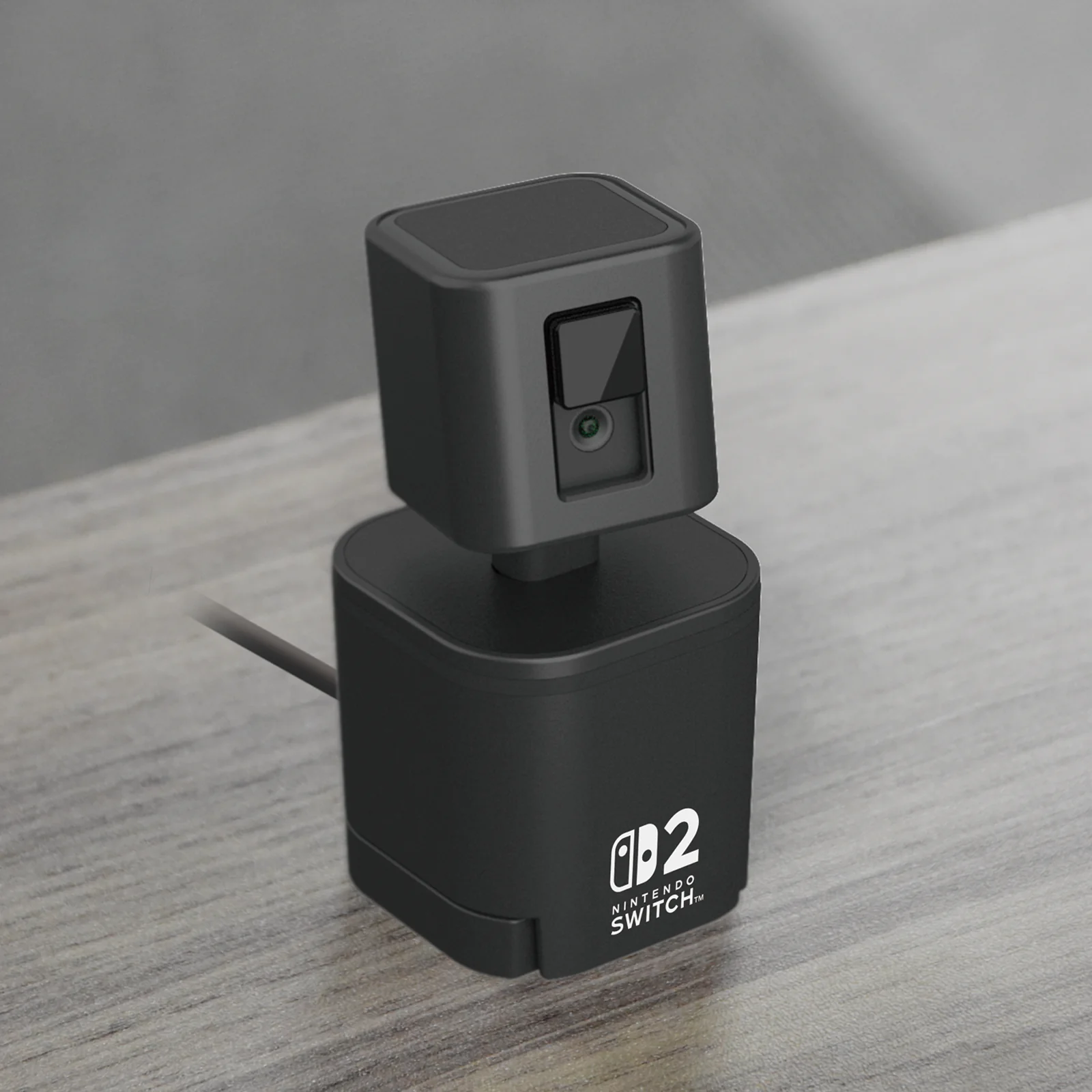 Telecamera USB nera per Nintendo Switch, su una superficie chiara. La telecamera è a forma di cubo.