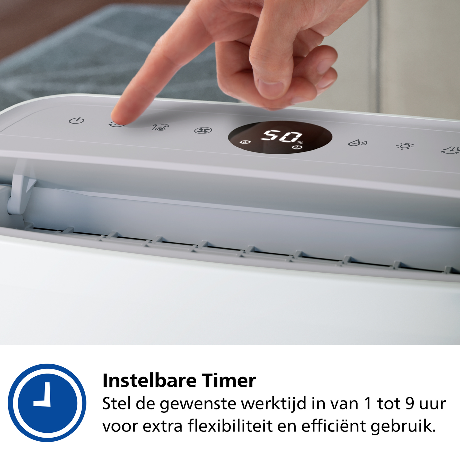 Hand pressing a button on a white dehumidifier. Digital display shows settings.