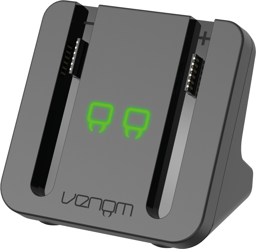 Egy töltőállomás két zöld fénnyel és a Venom logóval. Sötétszürke, és USB porttal rendelkezik.