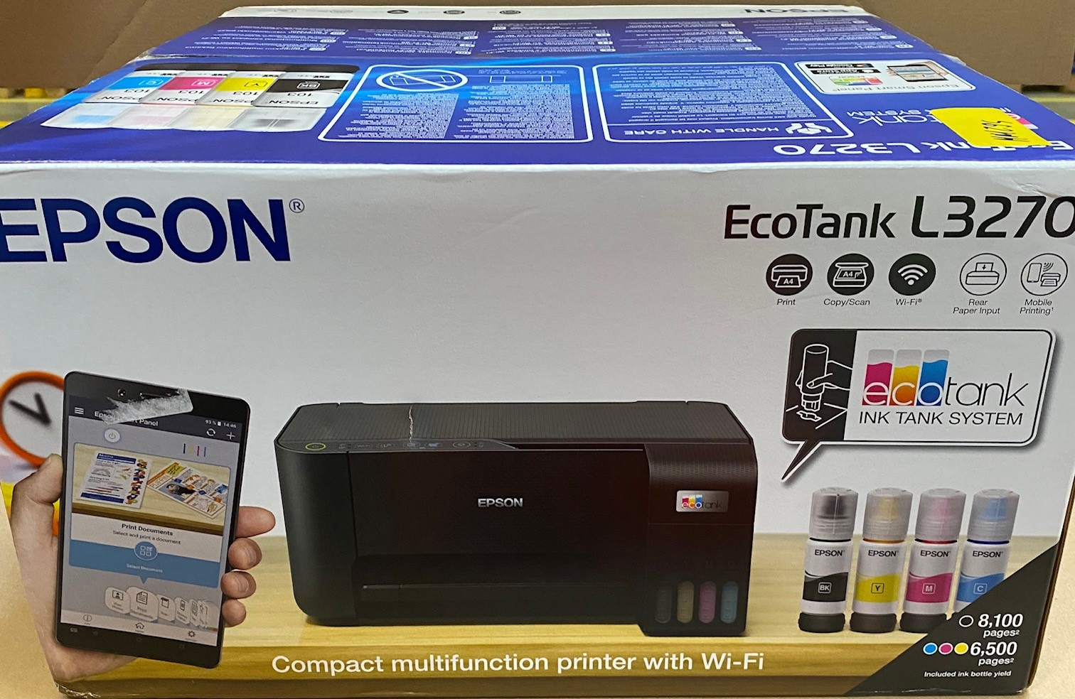 Pudełko drukarki Epson EcoTank. Obraz drukarki, butelki z tuszem i info o drukowaniu mobilnym.