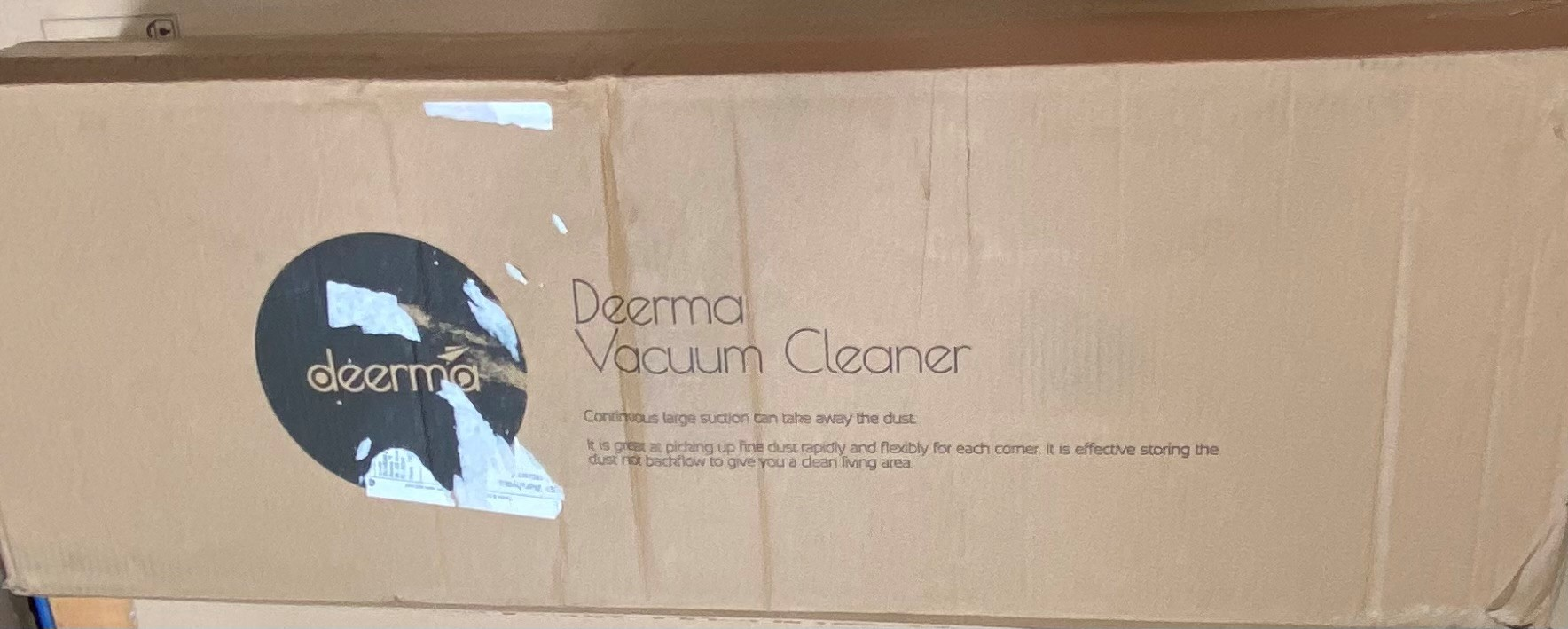 Pudełko odkurzacza Deerma. Pudełko jest brązowe z logo Deerma i nadrukowanymi informacjami o produkcie.