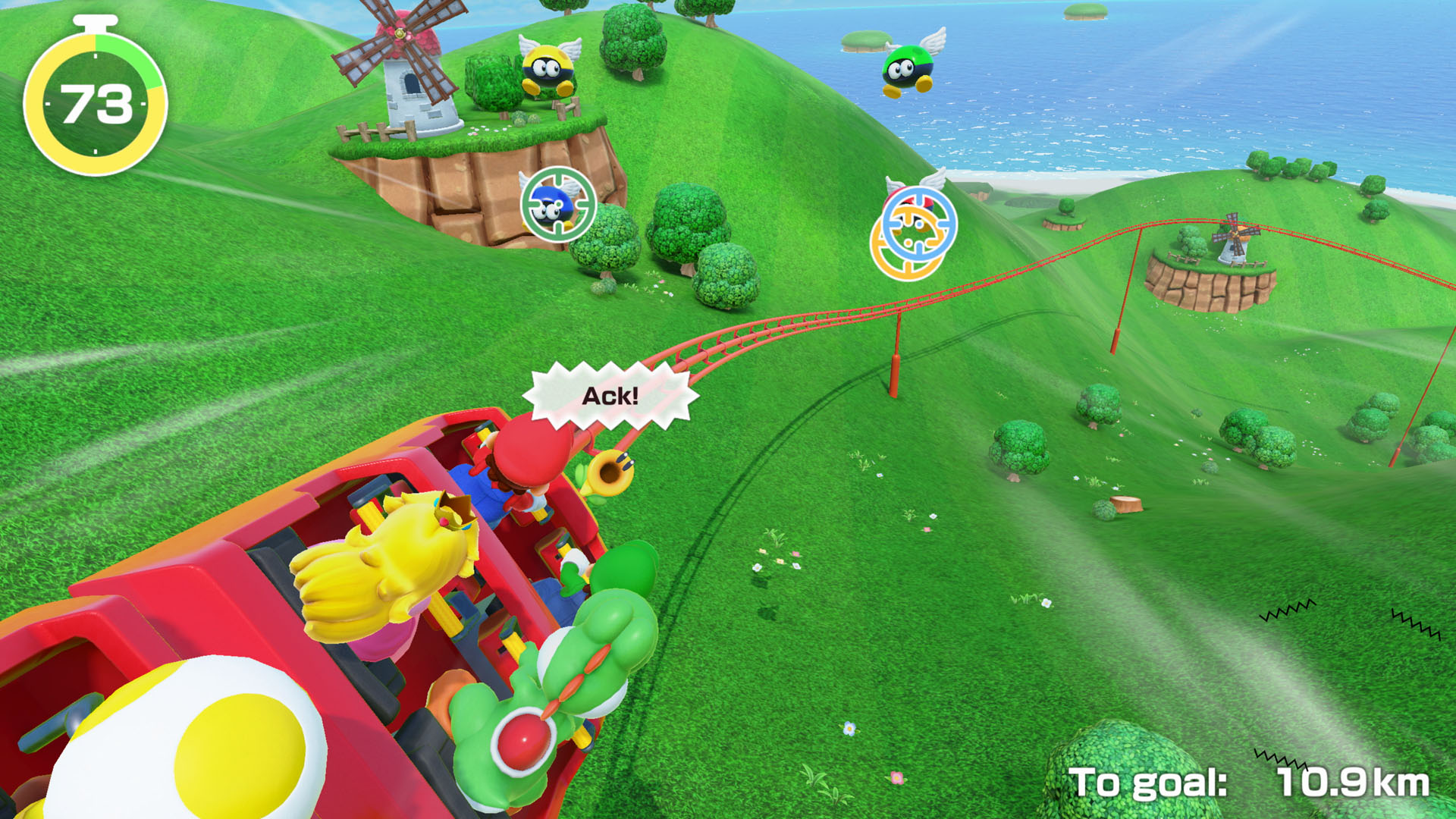 Mario Party oyunu. Karakterler yeşil bir tepede hız treninde.