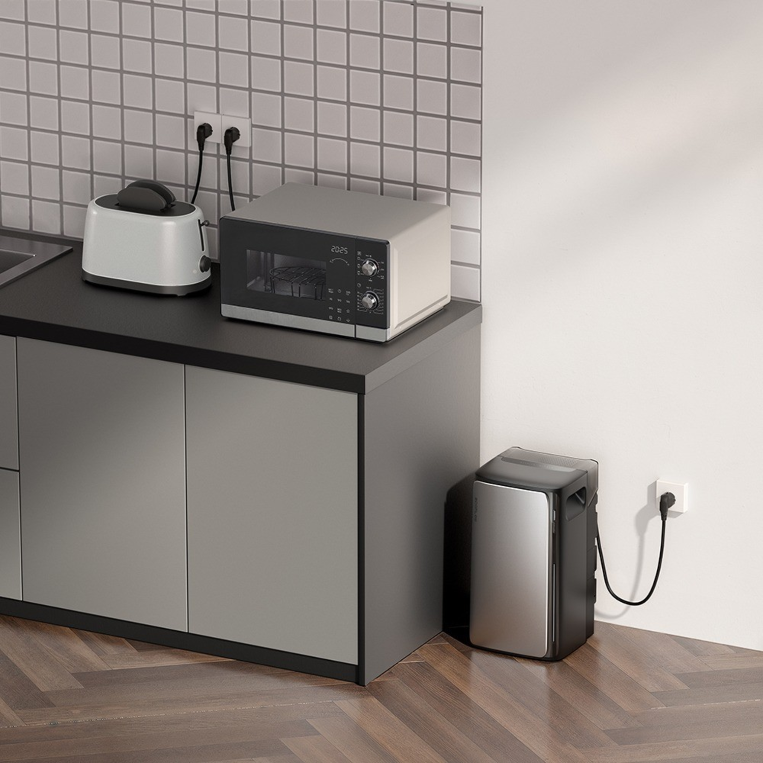 Kitchen with microwave, toaster, and mini-fridge. Grey cabinets and white tiled wall. Wooden floor.