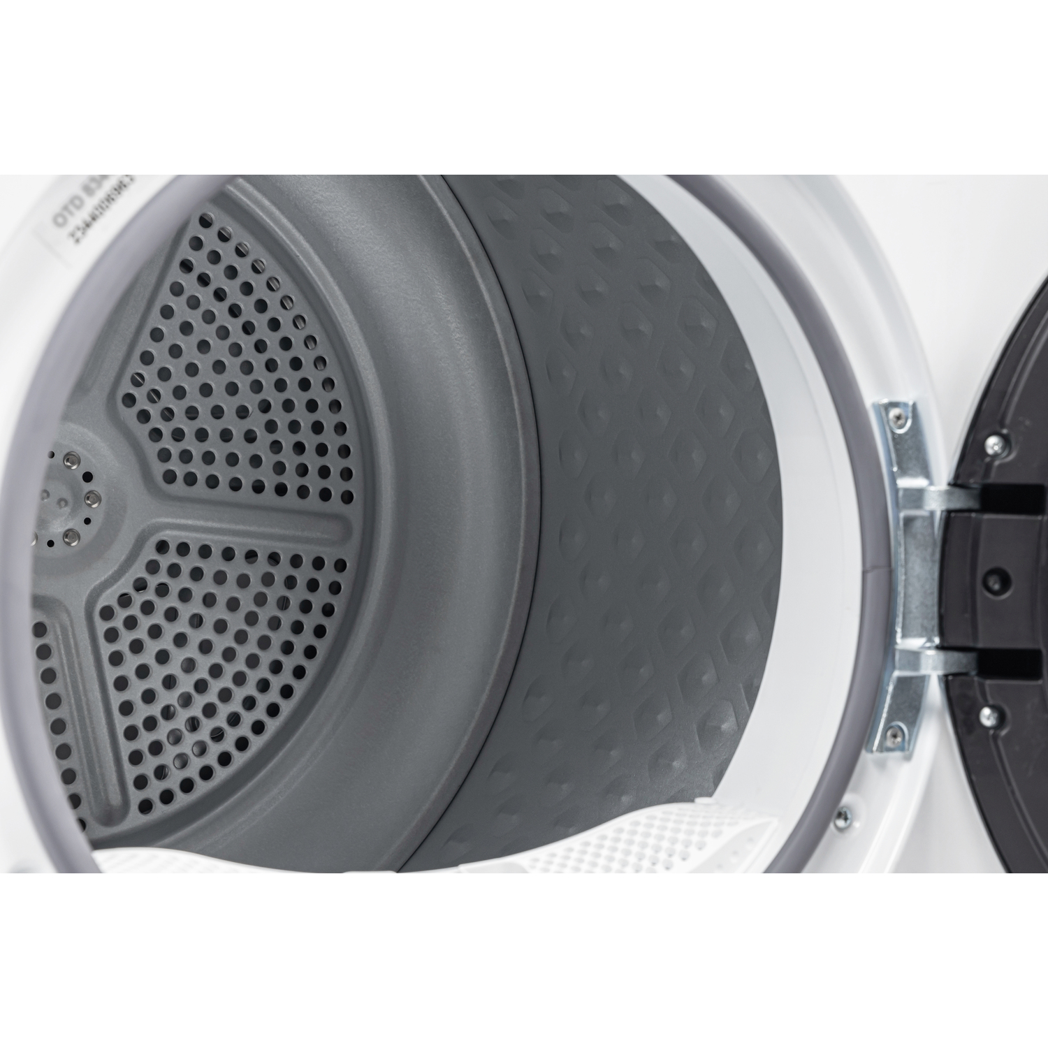 Inside of a dryer. Gray interior with a perforated back. White door frame and a black door are visible.