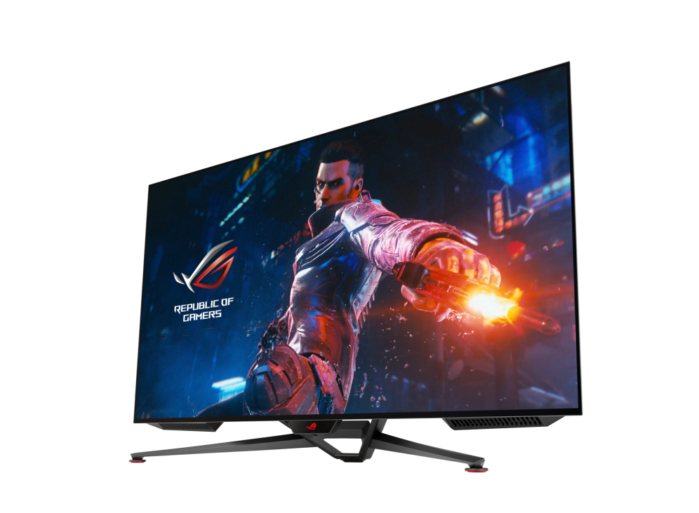 Un monitor gaming muestra una imagen futurista de un hombre con una pistola. El monitor es negro y tiene el logo ROG.