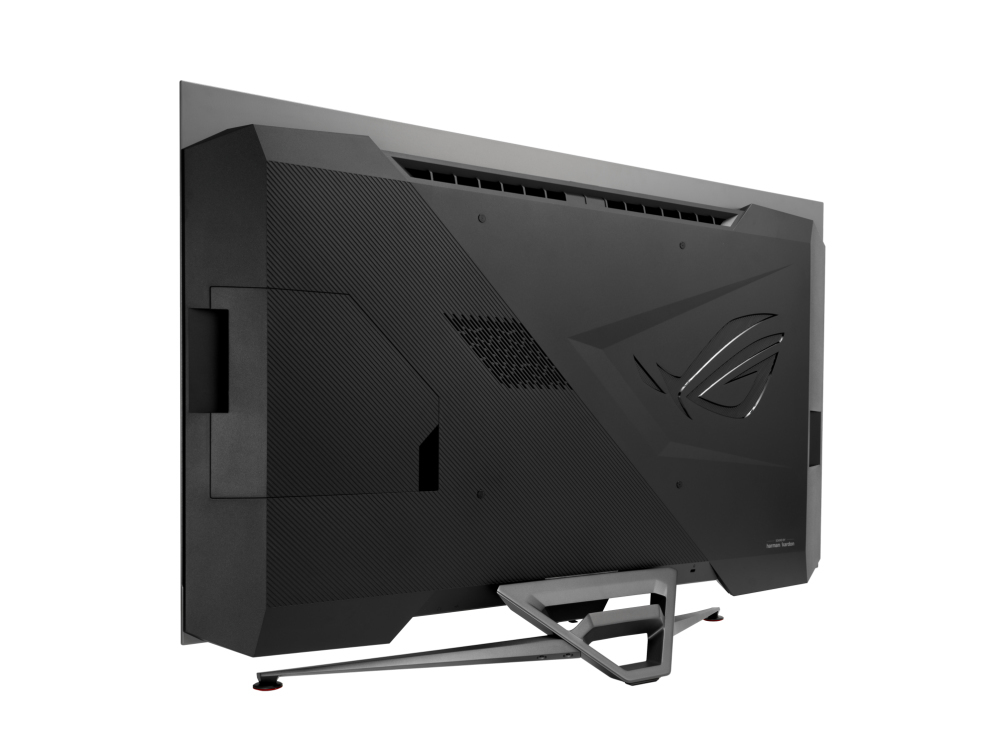 Parte trasera de monitor gaming negro. Parte superior y soporte grises. Logotipo ROG y marca Harman Kardon. Aislado sobre fondo blanco.