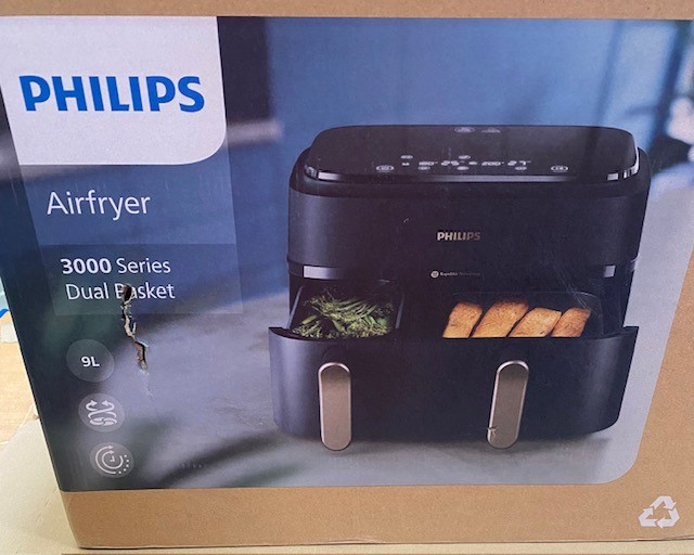 Frytownica Philips w pudełku, z widocznymi przegródkami na żywność, czarno-szara kolorystyka.